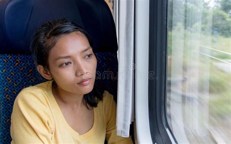 A Young Asian Woman With Mobile Phone Rides In Old Train Stock Image
