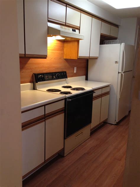 Cabinets before or after flooring. After - These old melamine 1980's cabinets look better ...