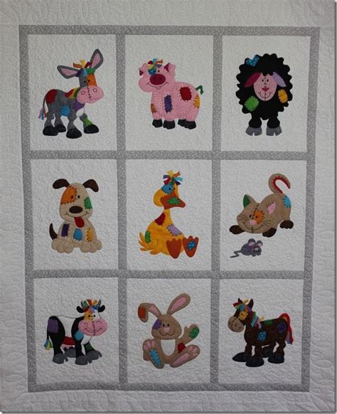 A Quilted Wall Hanging With Farm Animals On It