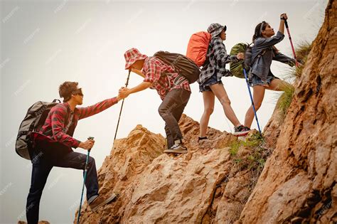 Premium Photo Team Of Climbers Man And Woman Hiker Holding Hands To