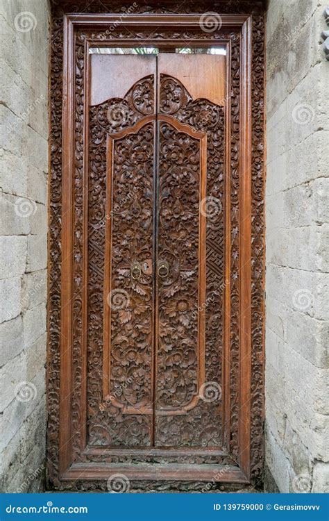 Balinese Wood Carved Doors With Traditional Local Ornaments Stock Photo