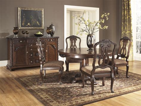 With a rich cherry finish, a smooth, contoured table top and a casual yet sophisticated veneer table design, this dining set will add a polished feel to your home. North Shore Round Pedestal Dining Room Set from Ashley ...