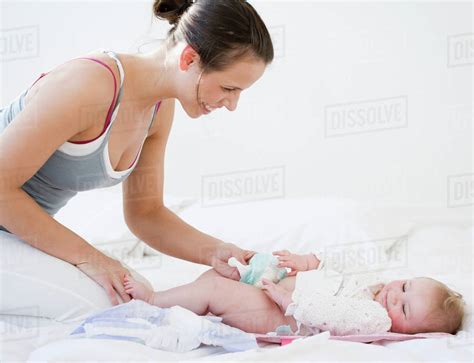 Mother Changing Babys Diaper Stock Photo Dissolve