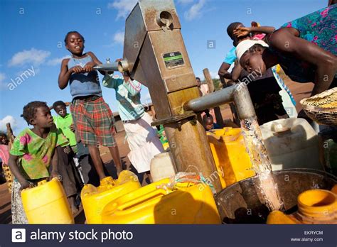 A Young Girl Pumps Clean Water From The Well Manica