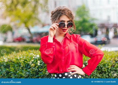 Portrait Of Pretty Girl In Sunglasses Posing To The Camera In Park She