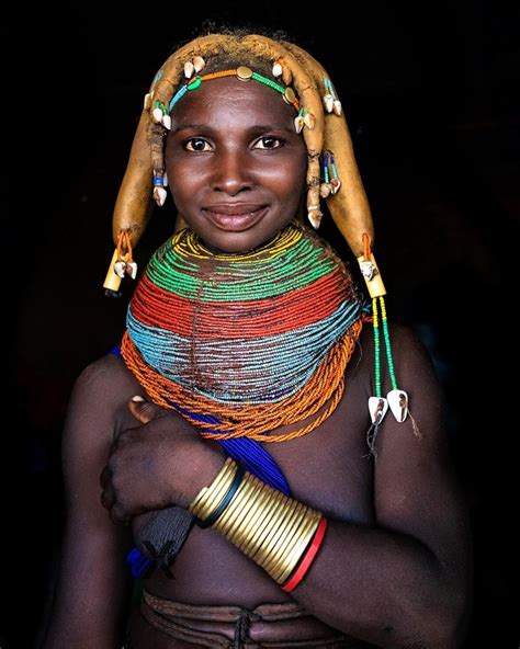 An African Woman With Colorful Jewelry On Her Head