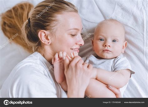 Top View Mother Cuddling Her Infant Baby Bed Stock Photo