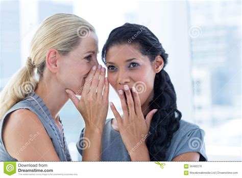Businesswoman Whispering Gossip To Her Colleague Stock Photo - Image of ...