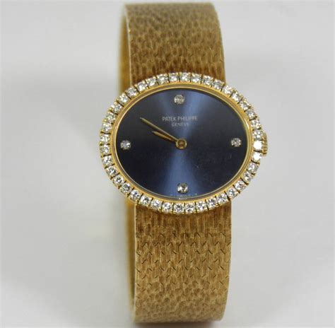Patek Philippe Ladys Yellow Gold And Diamond Bracelet Watch With Blue