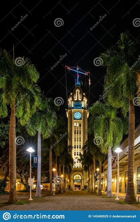 Aloha Tower Lit Up At Night With Path Lined With Palm Trees Stock Image