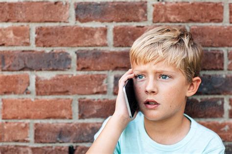 Serious Boy Talking On A Phone By Stocksy Contributor Kelly Knox