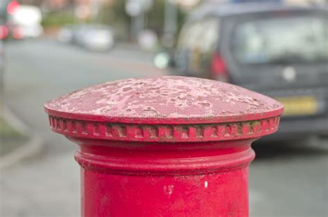 Red English Pillar Box Or Post Box Top On City Space Background Stock
