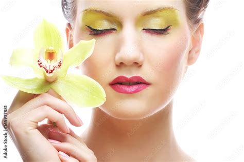 Young Woman With Bright Make Up Holding Orchid Stock Photo Adobe Stock