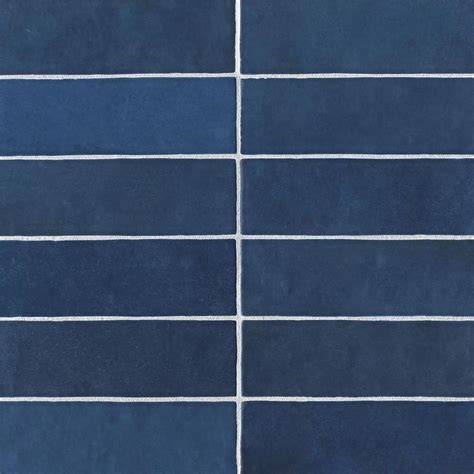 A Blue Tiled Wall With White Lines Painted On The Tiles In Different