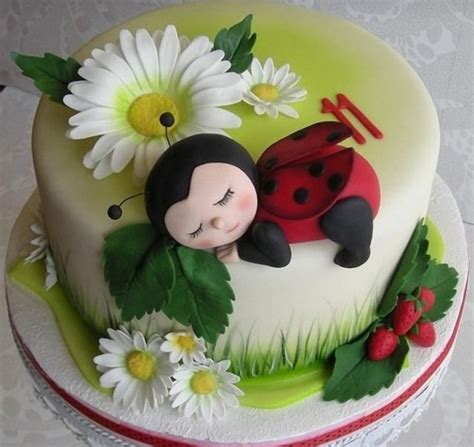 there is a cake with a ladybug and daisies on it