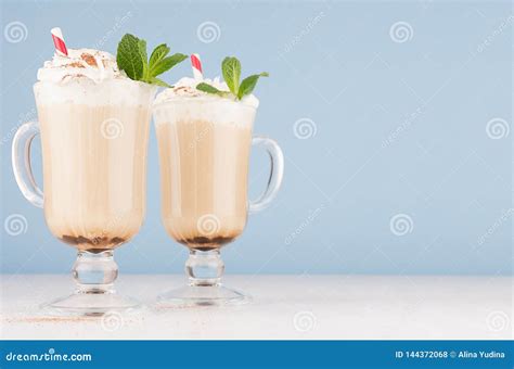Cappuccino Coffee In Two Elegant Glass With Whipped Cream Cocoa Powder