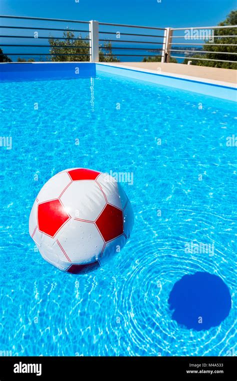 Beach Ball Floating On Water In Swimming Pool Stock Photo Alamy