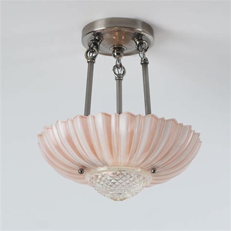 Sputnik chandeliers hang from a pink ceiling and light a blue marble herringbone floor in a galley style pink closet boasting facing the gold, scalloped socket covers are tole. Pink Lotus | Vintage Ceiling Light