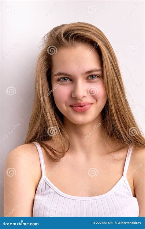 Portrait Of Young Caucasian Female With Long Natural Hair Looking At Camera Happily Stock Image