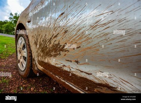 Close Up Of Muddy Car Wheel And Mud Splattered Body Near Wheel Arch