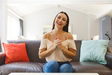 Caucasian Woman Sitting On Couch Having Video Call In Living Room Smiling Stock Image Image