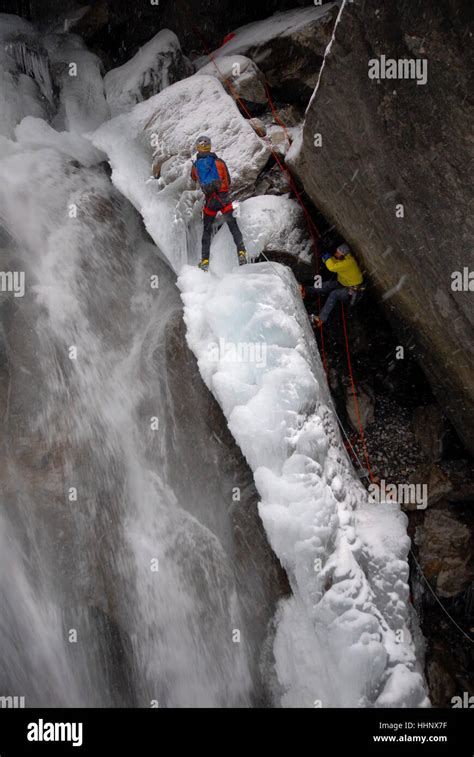 Photographer Suspended From Fixed Climbing Ropes On Edge Of Partially