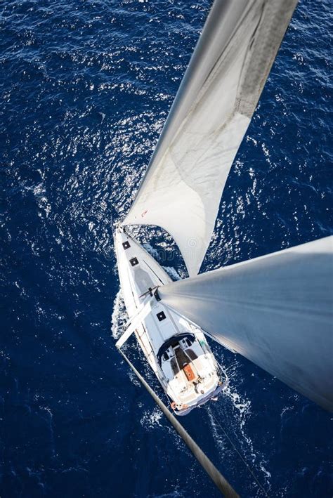 Sailing Yacht From Mast At Sunny Day With Deep Blue Ocean Stock Photo