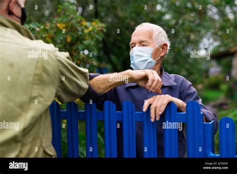 Good Neighbors Greet Each Other With Touch Of Their Elbows Safe
