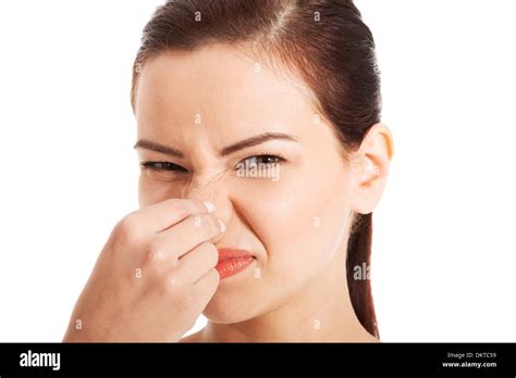 Portrait Of A Young Woman Holding Her Nose Because Of A Bad Smell Stock