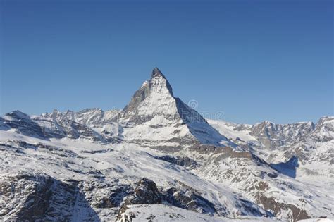 Matterhorn Mountain Peak In Alps In Winter With Snow And Clear Blue Sky