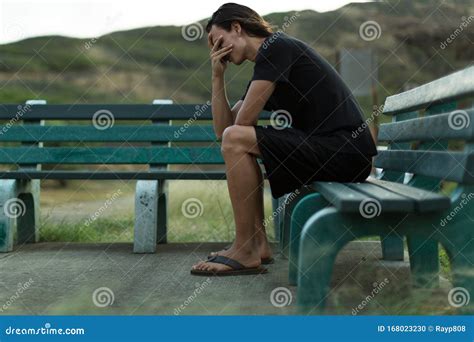 Sad Depressed Man Sitting On A Park Bench Stock Photo Image Of Blue