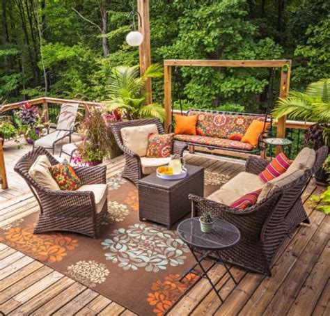 Add patio umbrellas at the dining area and coordinate it with furniture. 30 Ideas to Dress Up Your Deck | Midwest Living