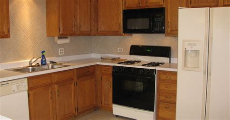 Staining and painting only changes the color of your cabinets. Best way to spruce up finish on medium oak Kitchen Cabinets | Hometalk