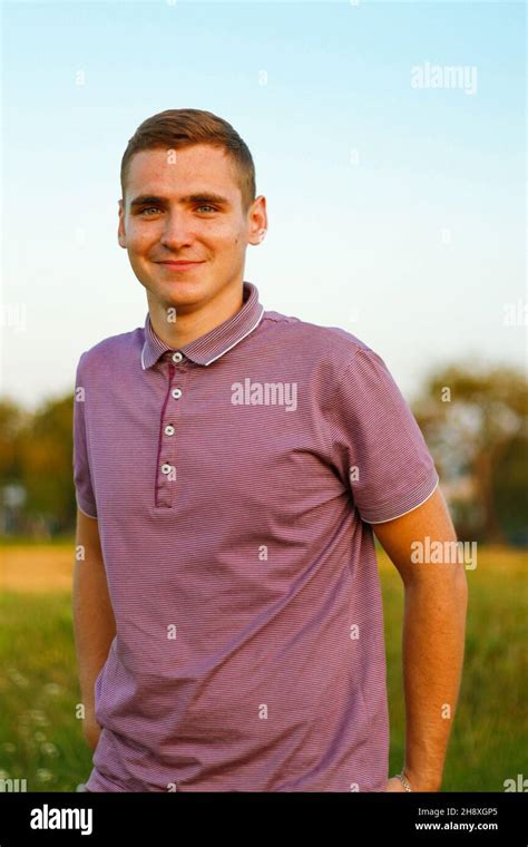 Happy People Portrait Of Serious Young Brunette Man In Purple Polo