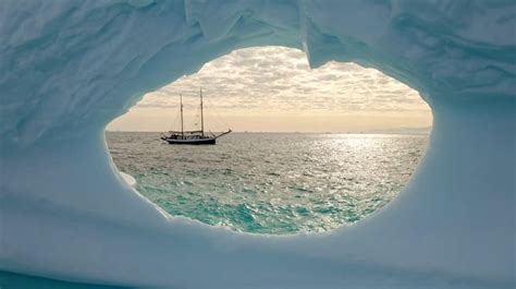A Boat Is Seen Through An Ice Cave