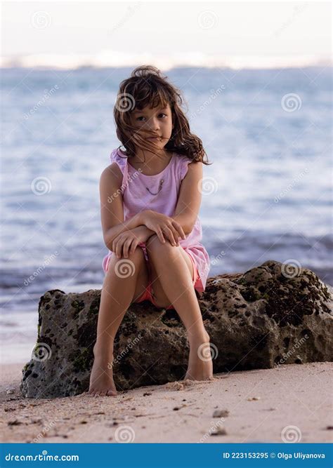 Young Girl Sitting On The Rock Near The Ocean Smiling Girl Happy