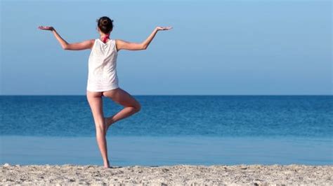 Sexy Girl With A Beautiful Ass Practices Yoga On The Beach Sand Beach Stock Footage