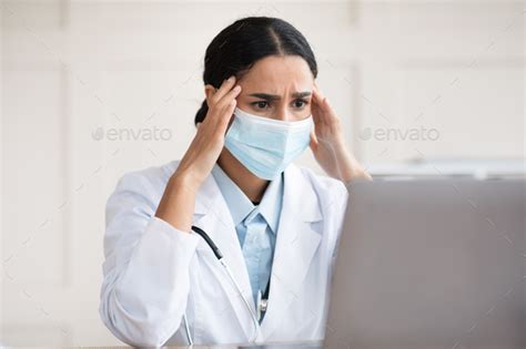Exhausted Arab Woman Doctor Having Headache Working During Pandemic