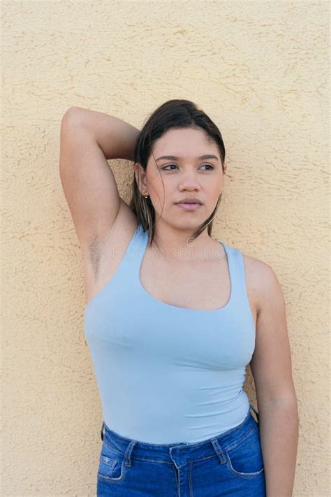Young Natural Woman With Unshaven Armpits Looking To The Side Stock