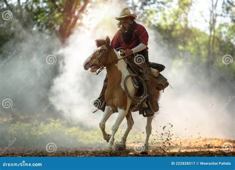 The Western Cowboy Rode In His Hand Holding A Rope At Speed Stock