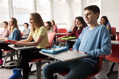 Happy High School Students Attending A Class In Modern Classroom Stock