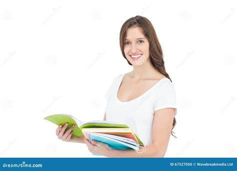 Portrait Of Happy Female College Student Holding Books Stock Photo