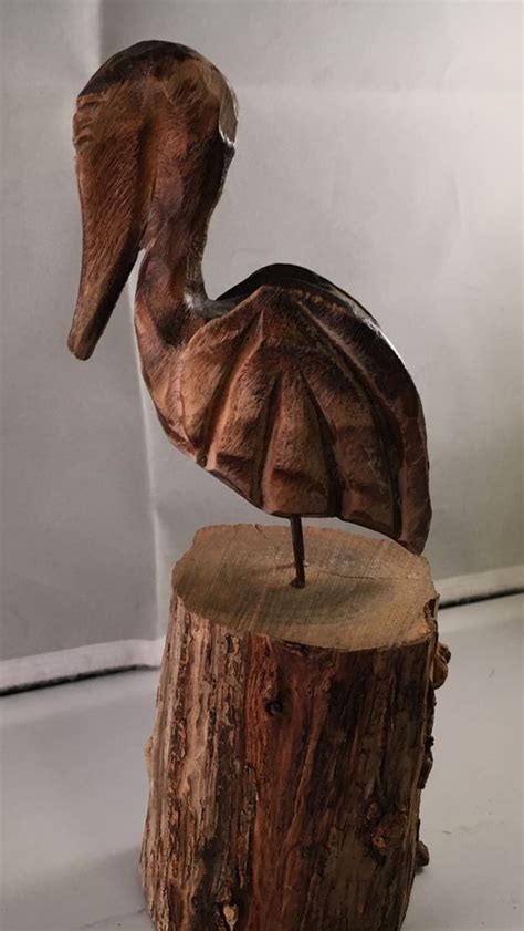 Man lifting woman from ledge bronze sculpture is sure to what are the shipping options for sculptures? Carved Wooden Pelican Folk Art Sculpture Unique Carving ...