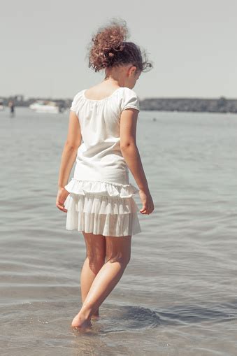 Pretty 8 Year Old Girl Posing On The Beach Stock Photo Download Image