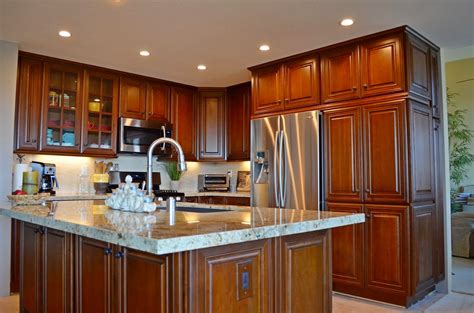 Granite counter tops, dark wooden cabinets, tile flooring and dual pane windows. Kitchen Cabinets Remodeling in Escondido - Julz Corp