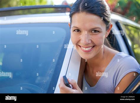 Brunette Attractive Woman Shows Her New Keys For Her Car Stock Photo
