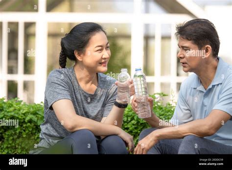 Asian Middle Aged Drink Water After Exercise Sport Training In Concept