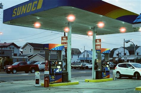 Red Car Parked Near Blue And White Gas Station Photo Free Image On