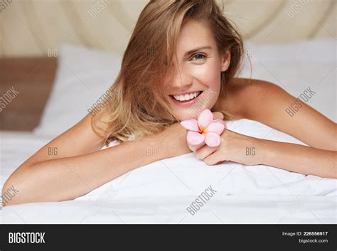 Cute Smiling Woman With Naked Body Has Shining Pleasant Smile Relaxes