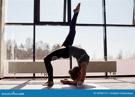 Silhouette Of A Young Woman Practicing The Concept Of Yoga Performing